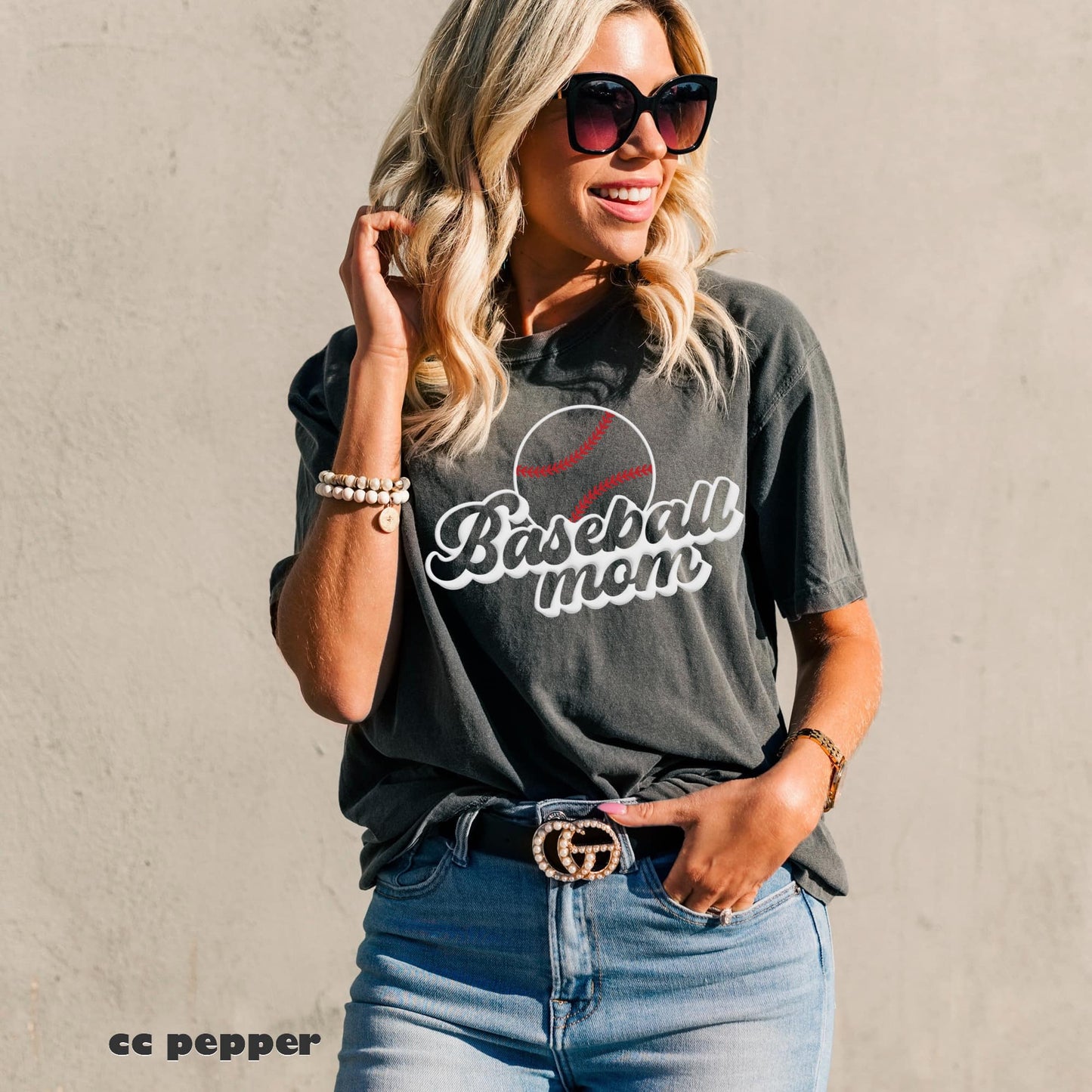 Photo is a mock up of the design. This design is white but has red threads for the baseball. It is pressed on a pepper comfort colors shirt. This design is a puff print and the design will raise & be a little puffy once pressed on shirt. Design says baseball mom with a baseball.