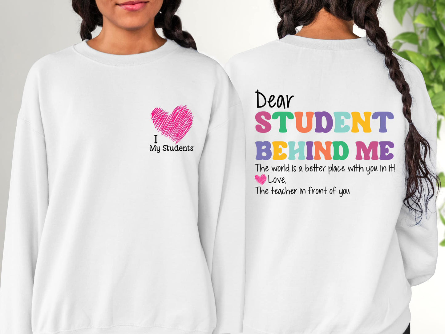 Photo is a mock up of the design. Design is colored and pressed on a white sweatshirt. Design says Dear student behind me, the word is a better place with you in it. Love the teache rin front of you. Design also has a pocket option which is a a pink heart that says I love my students.