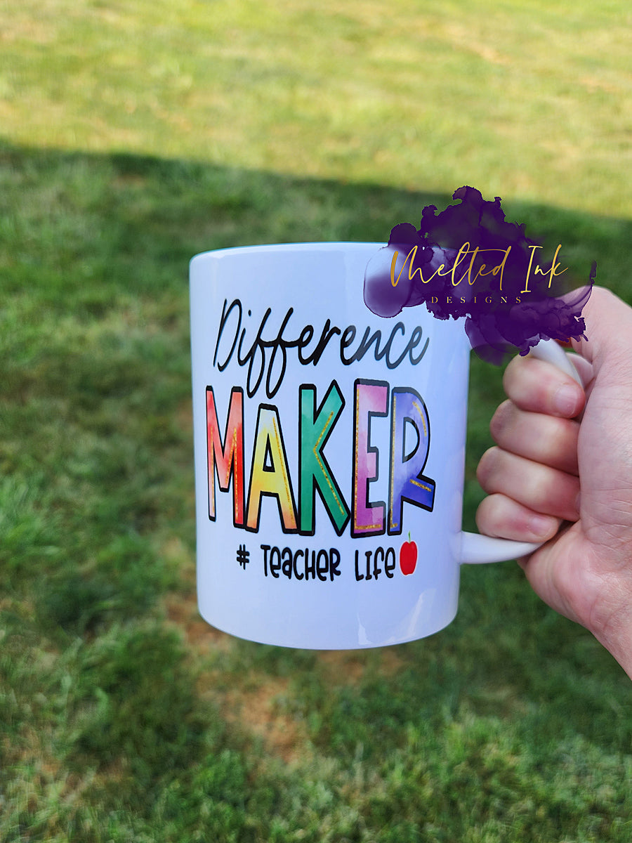 Photo is of a 15 oz mug that says Difference Maker #Teacherlife. Design printed on both sides.