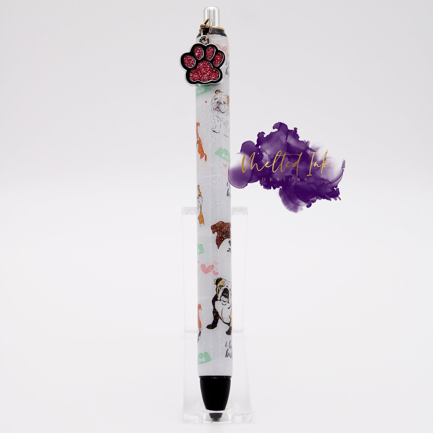 Photo is an epoxy ink pen and has a vinyl pen wrap with several different colored english bulldogs and says I love my bulldog throughout design. Has a glitter overlay and a pink paw charm. Comes with black ink.
