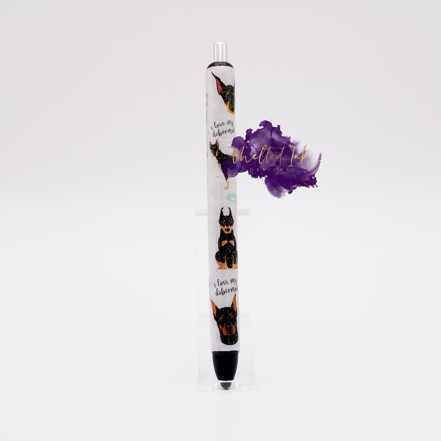 Photo is an epoxy ink pen and has a vinyl pen wrap with dobermans on it and says I love my doberman. Has a glitter overlay and comes with black ink.