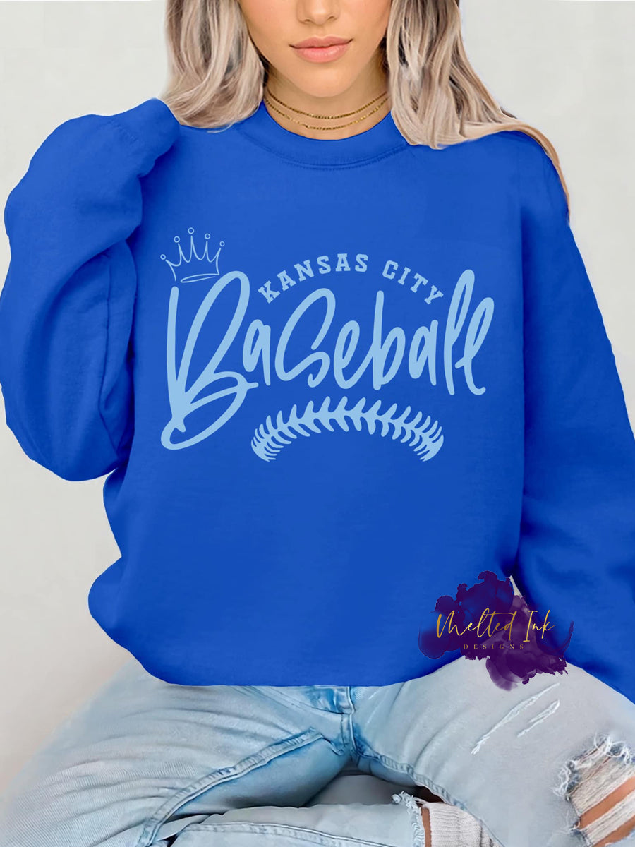 Kansas City baseball shirt featuring a bold crown graphic and baseball stitching detail. Perfect for showing off your Kansas City baseball pride at game day events and everyday casual wear. Ideal for baseball fans looking to showcase their love for the team in style.