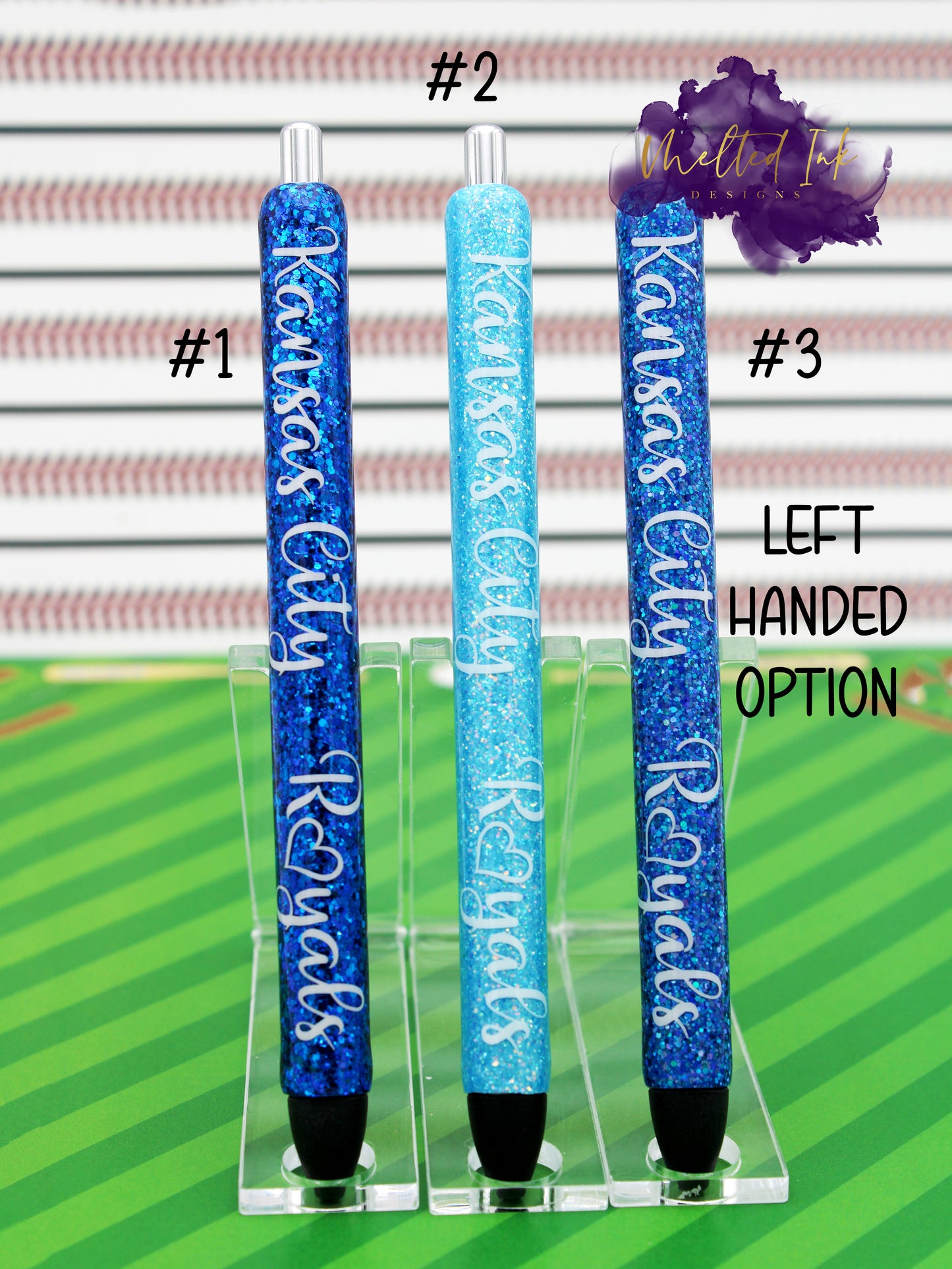 Photo consists of 3 epoxy glitter pens. #1 is a dark blue glitter, #2 has light tiffany blue glitter and #3 has a blue glitter. All there have the words Kansas City Royals. Comes in left or right handed options and they come with black ink.