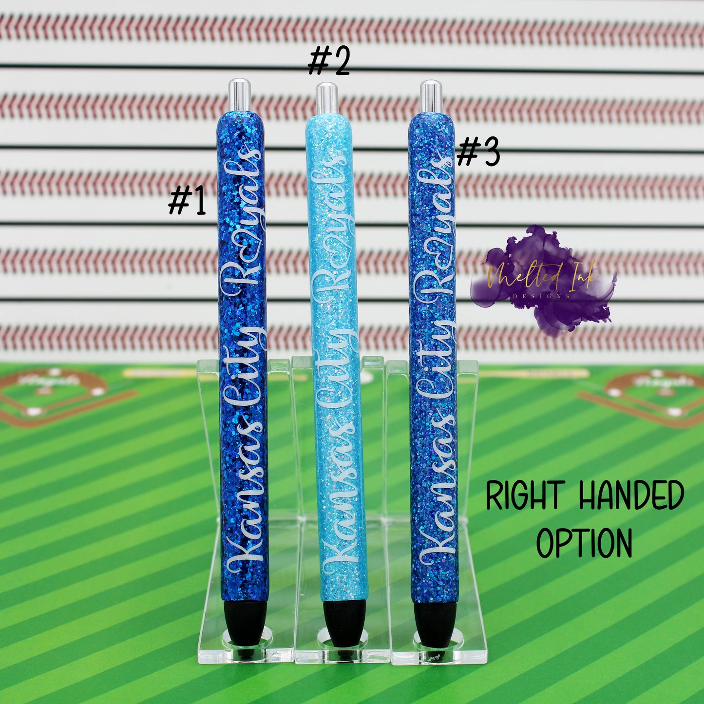 Photo consists of 3 epoxy glitter pens. #1 is a dark blue glitter, #2 has light tiffany blue glitter and #3 has a blue glitter. All there have the words Kansas City Royals. Comes in left or right handed options and they come with black ink.