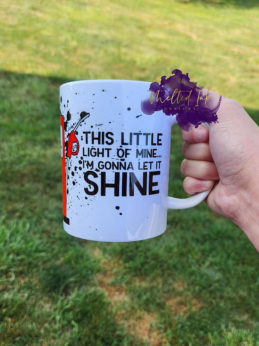 Photo is of a 15oz mug that says this little light of mine...i'm gonna let it shine and has a gas tank with pump almost on empty.