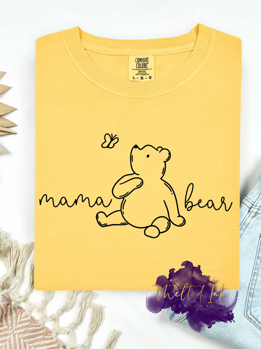 "Charming line art of a gentle bear admiring a butterfly, beautifully paired with the script phrase 'mama bear' to celebrate the love and strength of motherhood."