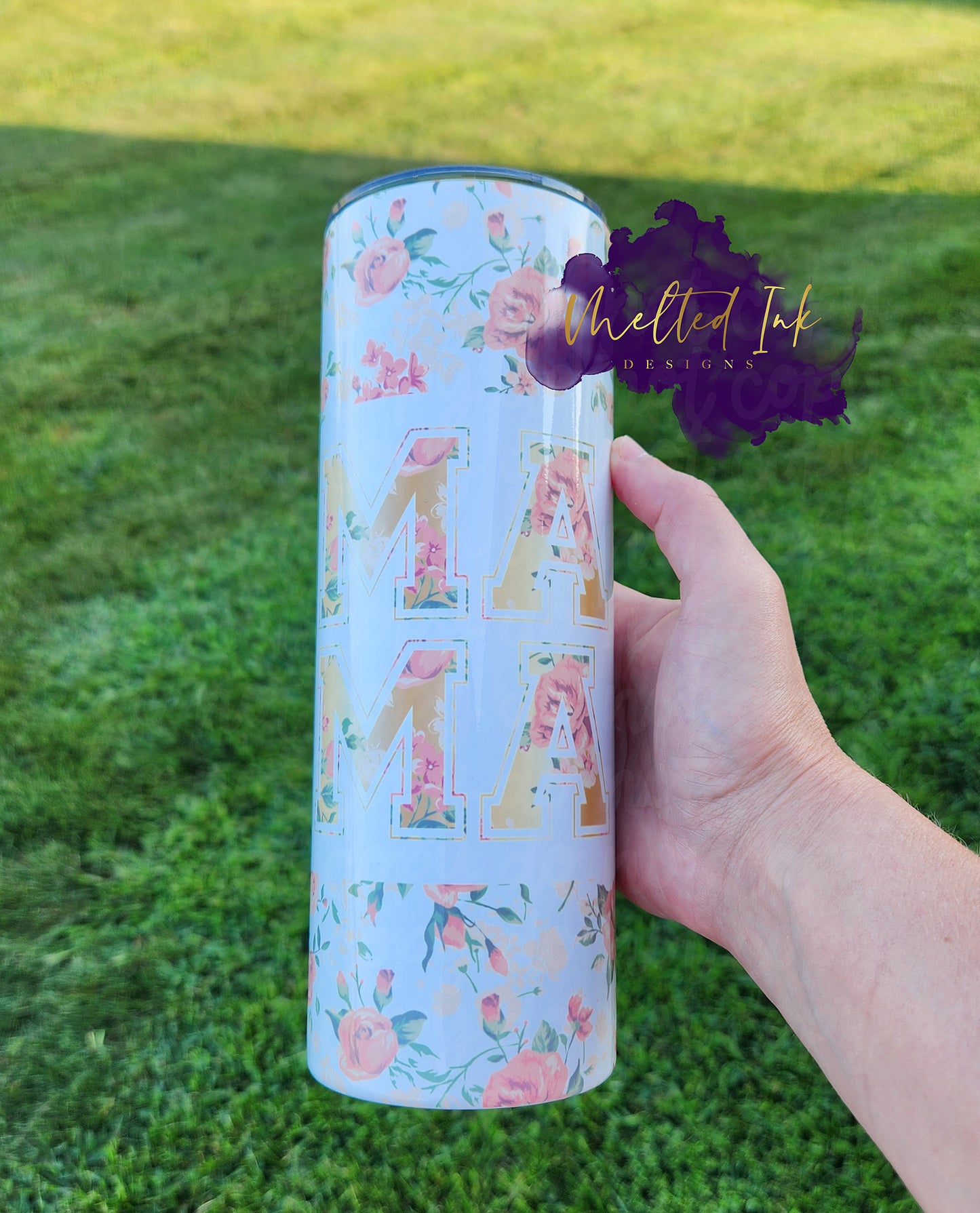 Photo is a 20oz pink/orange floral print that says mama with the letters MA stacked on top of the other to spell out the word mama.