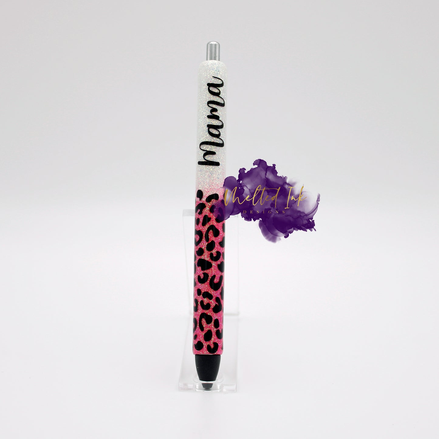 Photo consists of an epoxy glitter ink pen. The pen has white and pink ombre with leopard print over the pink. The word MAMA is on the white glitter. Pen comes in black ink. Option for right or left handed.
