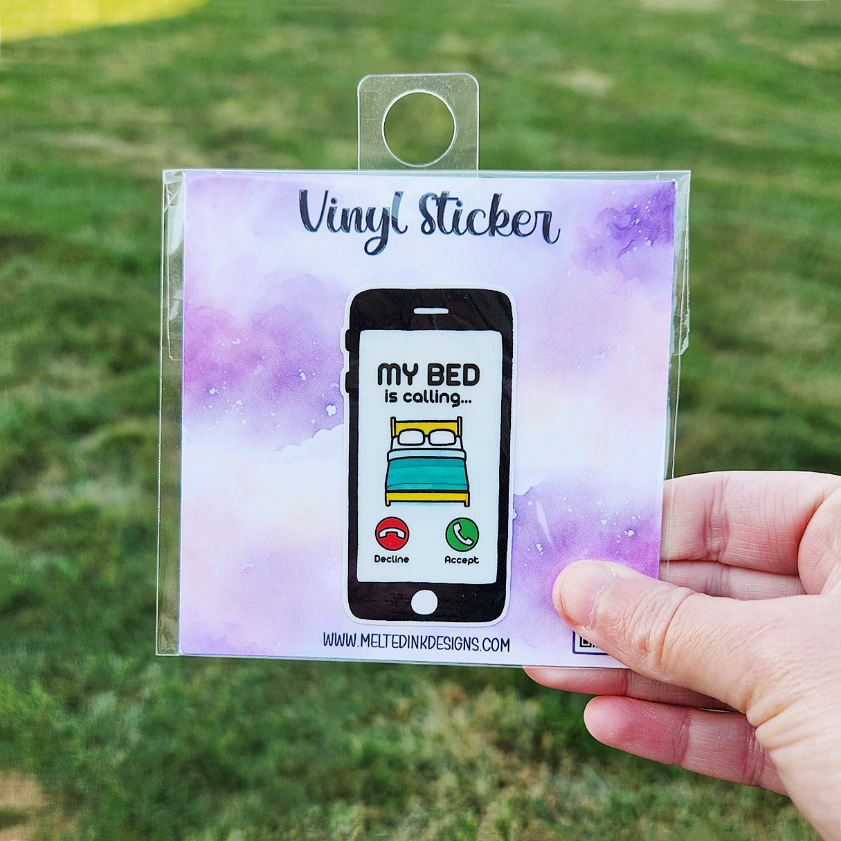 Vinyl Sticker is a picture of a phone. Showing on the screen of the phone is a picture of a bed. The sticker says my bed is calling.