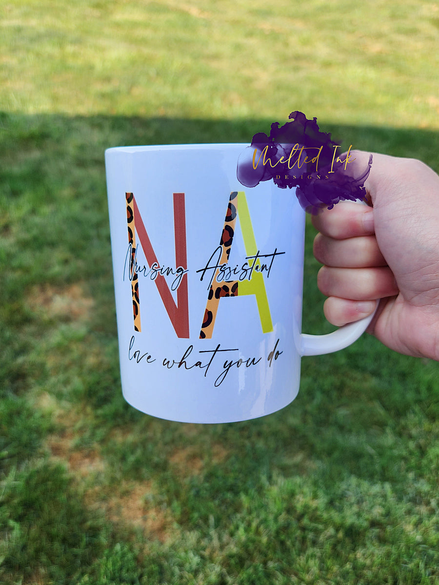 Photo is of a 15oz mug that says NA Nursing Assistant love what you do.