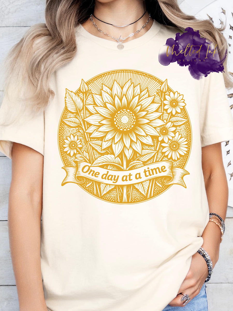 Intricate sunflower mandala design with the uplifting phrase “One day at a time” in vintage script, symbolizing hope, healing, and mindfulness.