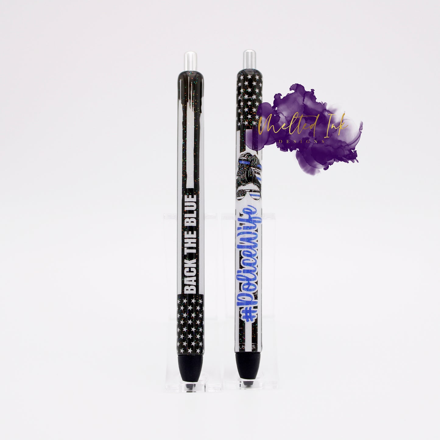 Photo consists of 2 different epoxy pens. One says back the blue with the thin blue line police flag and the other says #policewife over the thin blue line police flag. Both have glitter overlay and comes with black ink.