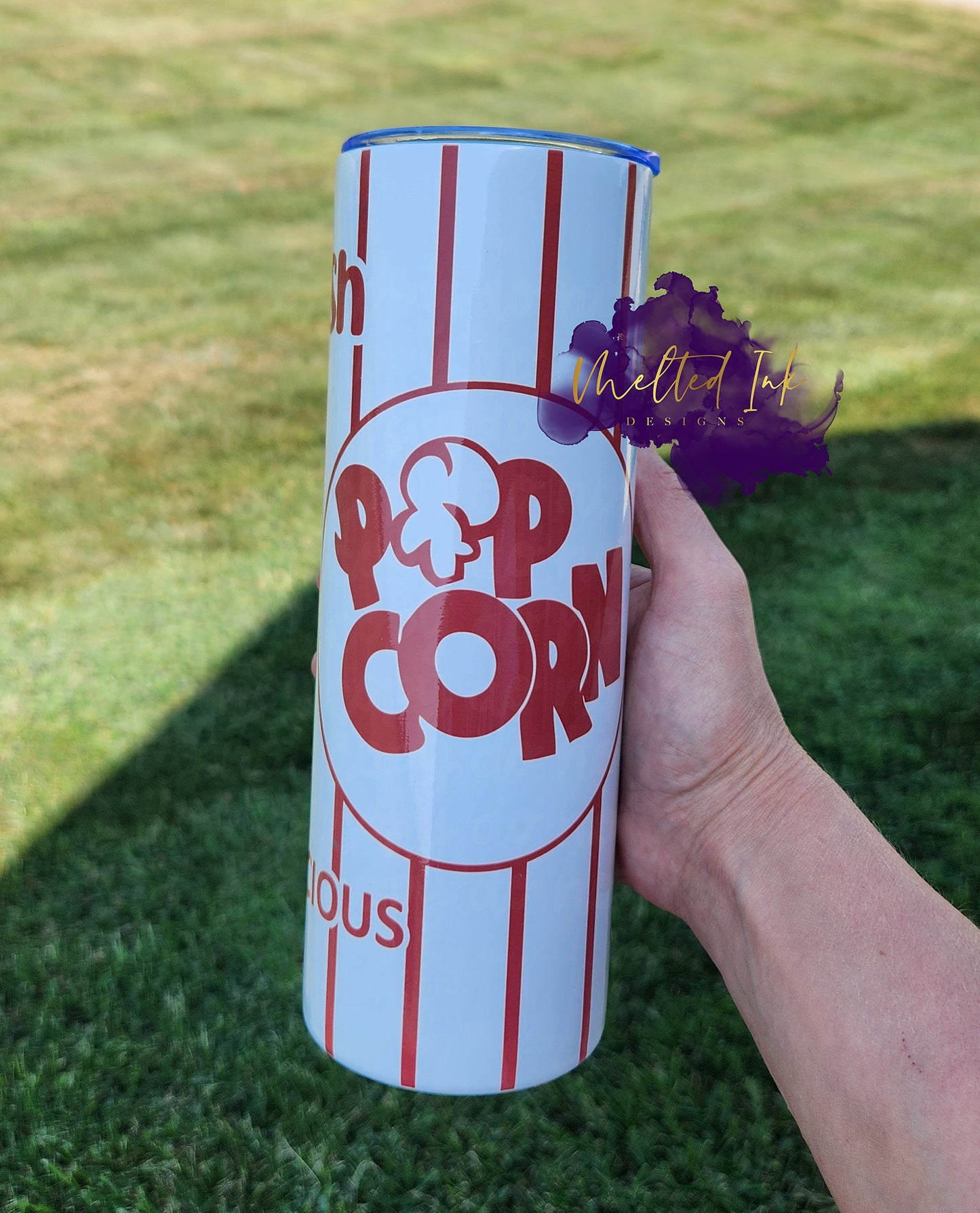 Photo consists of a 20oz tumbler that says Fresh Popcorn Delicious.