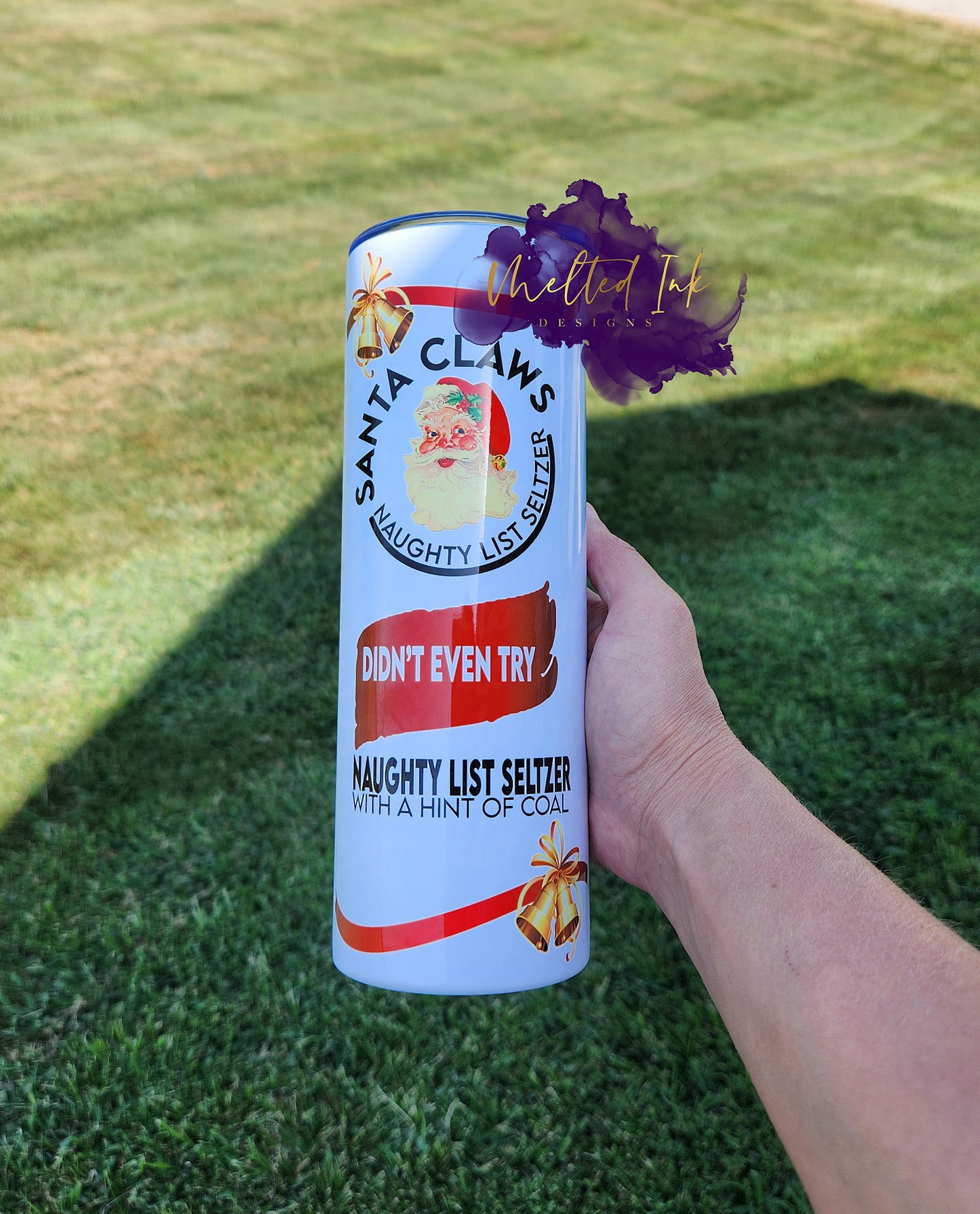 Photo is of a 20oz tumbler that resembles alcohol drink. It shows Santa and says Santa Claws Naughty List Seltzer with a hint of coal.