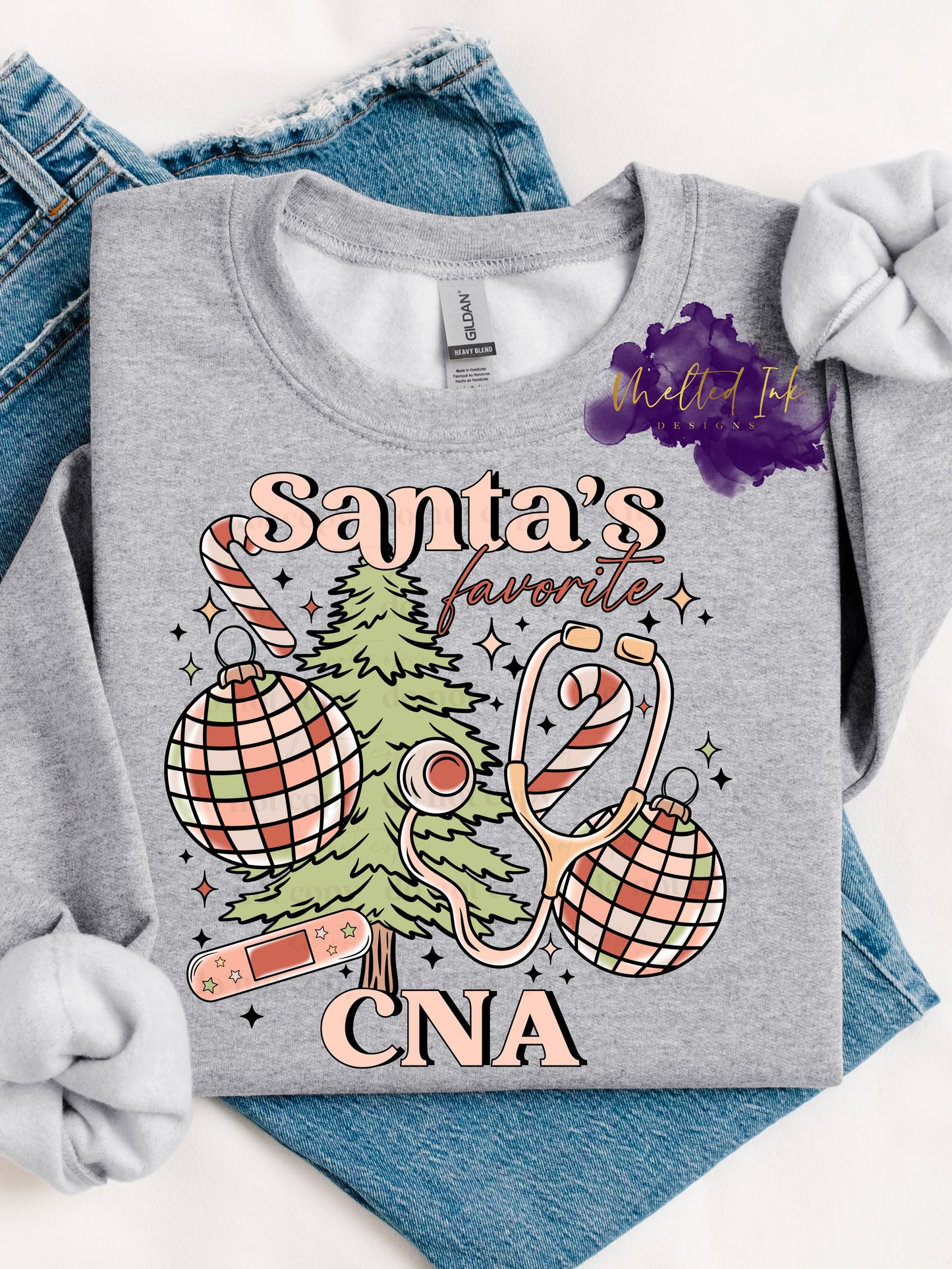 Photo is a mock up of design. Design is colored light pinks and light green and says Santa's Favorite CNA. Has picture of a christmas tree, ornaments, candy cane, stethascope and bandaid.