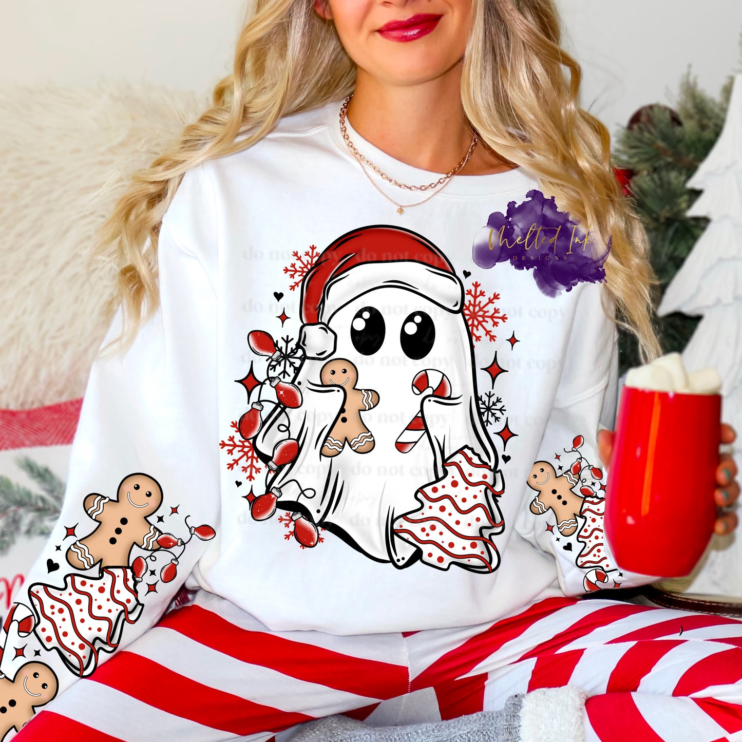 Photo is a mock up of design. The design is of a Ghost with Santa Hat holding a candy cane, gingerbread and Christmas Tree Cake and is on a white shirt.