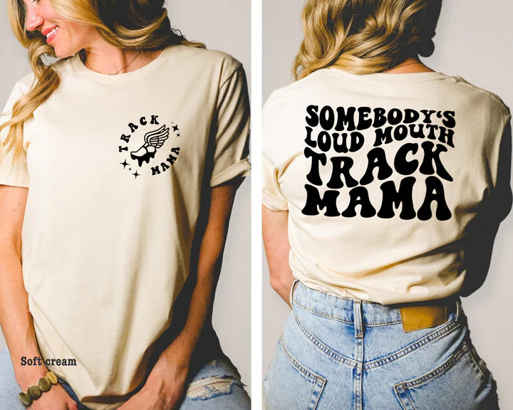 Additional picture shows pocket design with the main design on back of shirt. Pocket design says track mama and has a picture of a cleat with wings.
