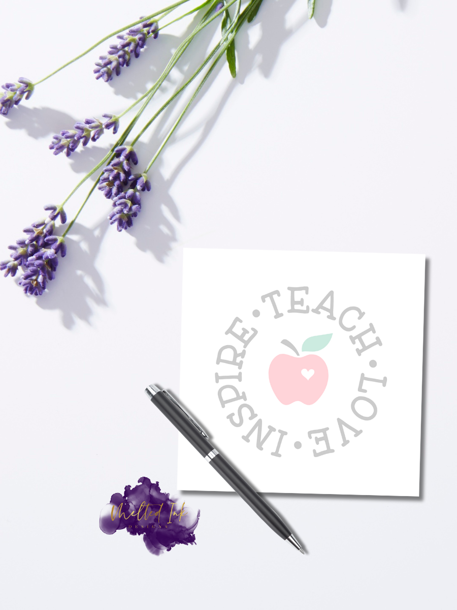 Notepad design featuring an apple with a heart and the words "Teach • Love • Inspire" in a circular layout around it.