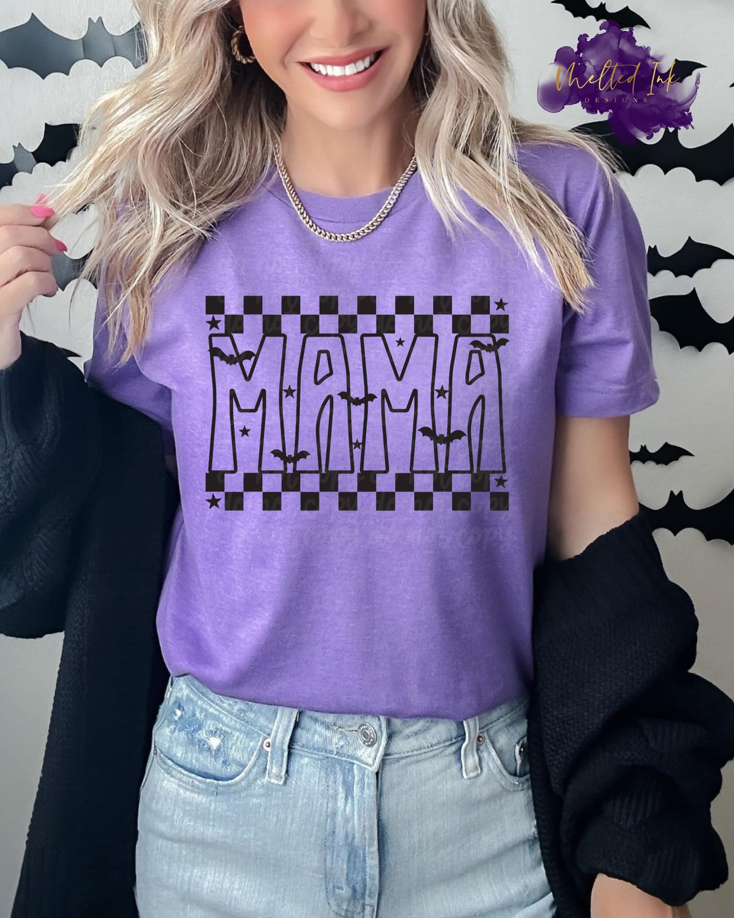 Photo is a mock up of the design. The design color is black and is pressed on a purple shirt. Design says MAMA and it includes stars and bats flying over the word MAMA. Checker print placed above and below MAMA.