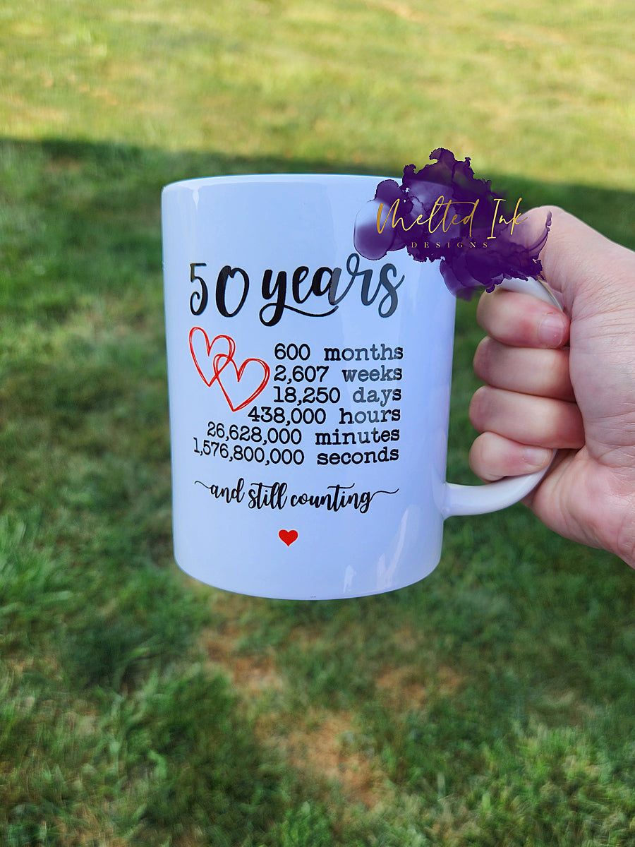 Photo is of a 15 oz mug that says 50 years with 600 months, 2,607 weeks, 18,250 days, 438,000 hours, 26,628,000 minutes and 1,576,800,000 seconds and still counting. 