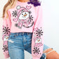 Photo is a mock up of design. Design is of a snowman with a pink hat and scarf. It says Baby it's cold outside. Has snowflakes and pink hearts in the background. 