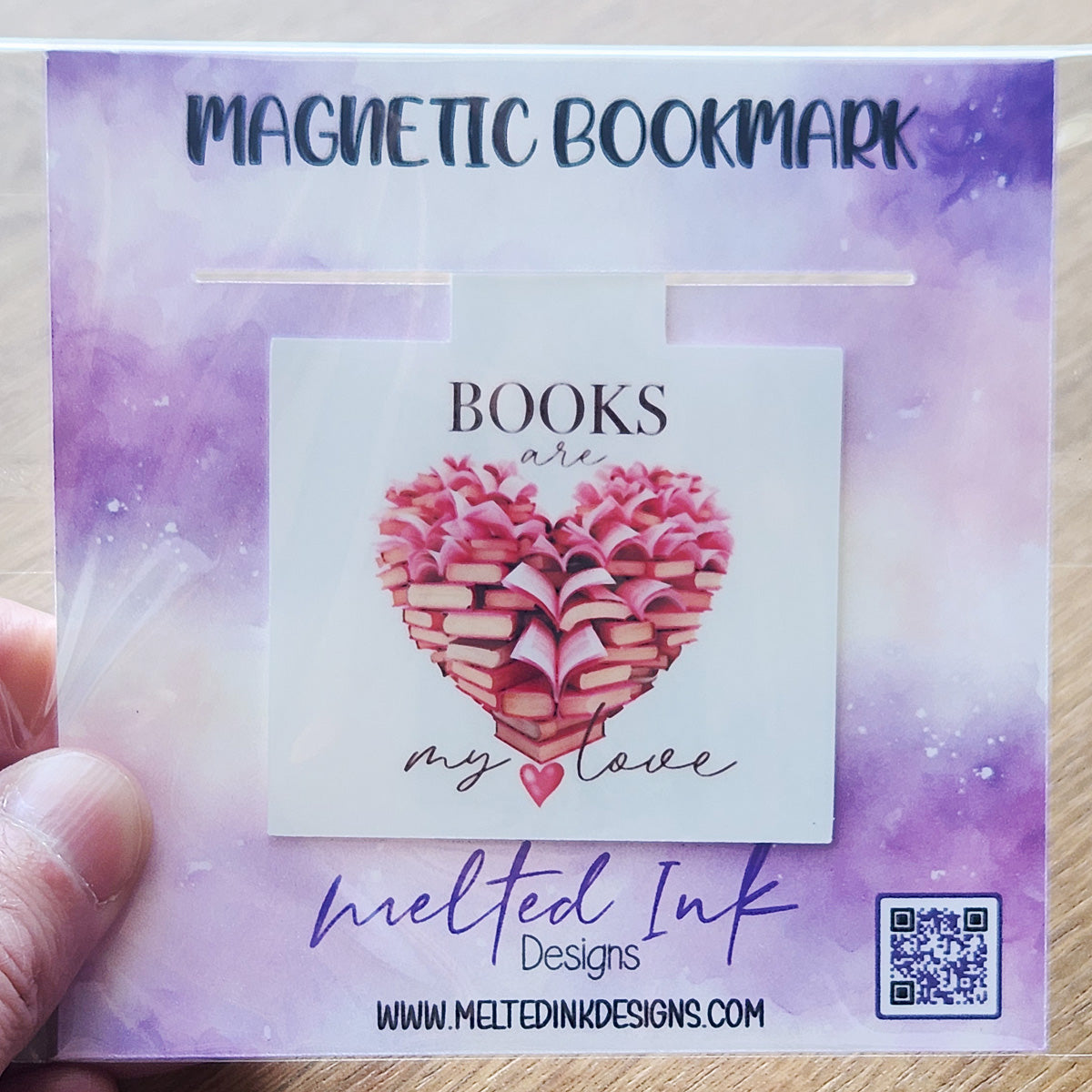 This magnetic bookmark beautifully expresses the sentiment "Books Are My Love," featuring an artistic design of stacks of books arranged in the shape of a heart.