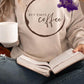 Photo is a mock up of the design. Design print is brown and is pressed on a sand colored sweatshirt. Design says but first coffee and has a circle around the words that appears as a coffee stain. 