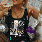 Photo is a mock up of design. Design is on a black shirt and says Cheers to the new year. Has a skeleton hand holding a wine flute with a balloon and confetti. 