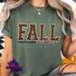 Photo is a mock up of the design. Design is a colored design and is pressed on a moss green colored shirt. The design says Fall Vibes. The word Fall is black and orange checkered. 