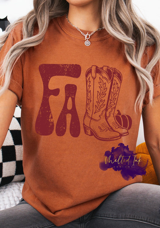 Shirt design with the word “FALL” in large retro distressed lettering, paired with an illustration of cowboy boots and a small pumpkin. A rustic, Western-inspired fall design for shirts, sweatshirts, and hoodies.