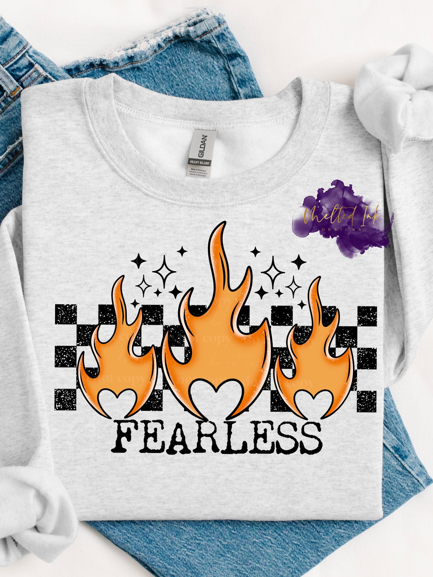 Shirt is a mock up of the design. Design is colored and is a picture of orange flames over rectangle checkered background and says Fearless. 