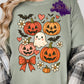 Design showing a cute smiling ghost surrounded by jack-o’-lantern pumpkins, hearts, bats, flowers, and a bow.