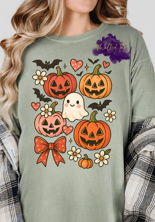 Design showing a cute smiling ghost surrounded by jack-o’-lantern pumpkins, hearts, bats, flowers, and a bow.