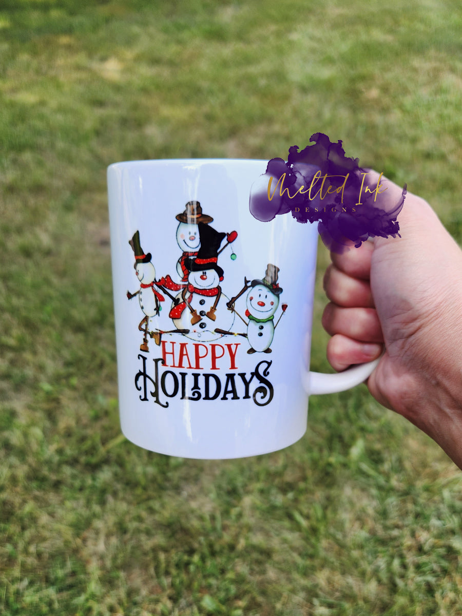 Photo is a 15 oz mug that says happy holidays. It has 4 snowmen on it. 