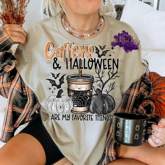 Photo is a mock up of the design. Design is colored and pressed on a sand colored shirt. Design says Caffeine and Halloween Are My Favorite Things. Design also consists of a white pumpkin with spider webs,  coffee cup with black spider web wrap, black pumpkin with spider web. Design also has bats and a tree in background. 