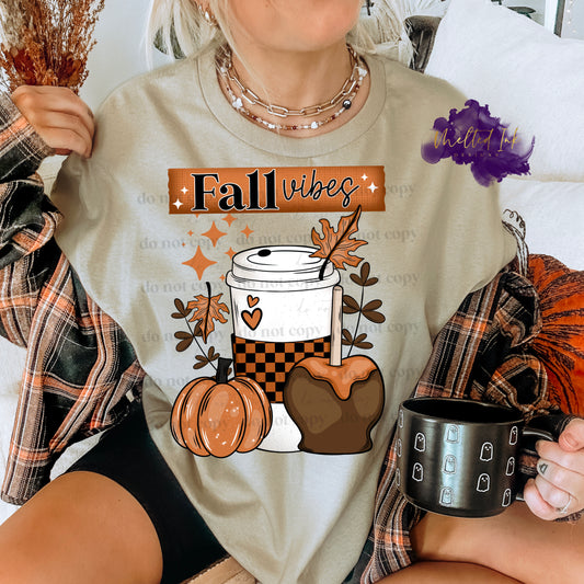 Photo is a mock up of the design.  Design is a colored design pressed on a sand colored shirt. Design says fall vibes and has a picture of a pumpkin, coffee cup and caramel apple. Also includes a couple leaves. 