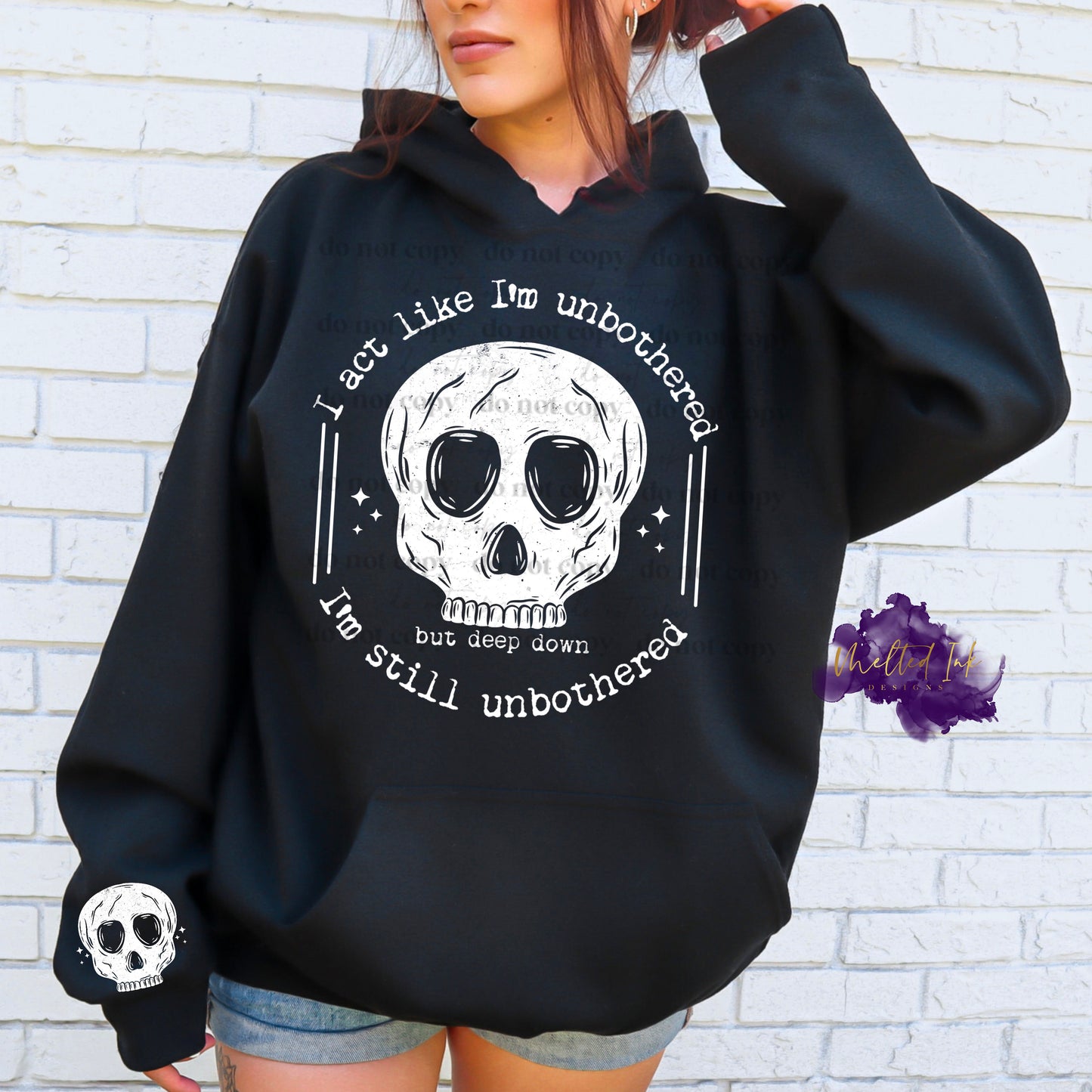 Photo is a mock up of the design. Design color is white and pressed on a dark blue sweatshirt. Design says I act like I'm unbothered but deep down I'm still unbothered. Has a picture of a skeleton head.