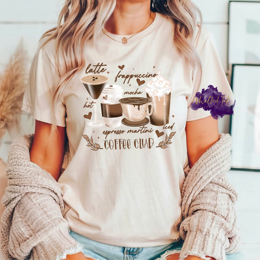 Photo is a mock up of the design.  Design is a colored design and is pressed on a light tan colored shirt. Picture shows a latte, iced frappuccino, and expresso martini. Also includes these words and at the bottom under the coffee items the design says coffee club. 