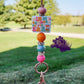 This lanyard features a focal bead that says "In My One More Chapter Era," adorned with cute little book illustrations. The design is accented with rhinestone spacers and colorful silicone beads in orange, bluish, and pink tones, creating a vibrant and playful look. It also includes a keyring for convenience. 