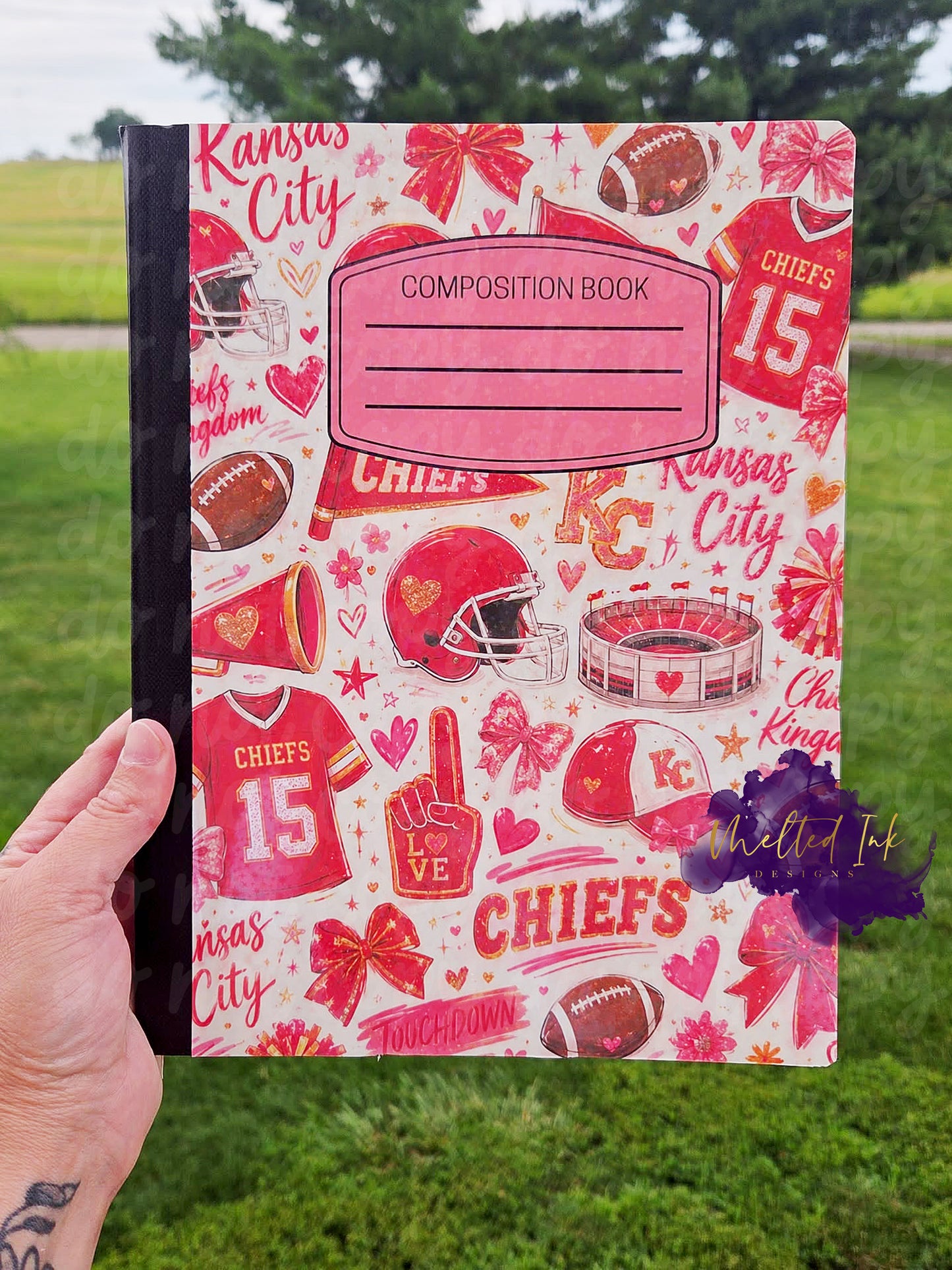 Pink, Red and Gold Kansas City football-themed composition notebook featuring football helmets, footballs, jerseys, bows, pom-poms, hearts, stadium illustrations, and game day-inspired artwork surrounding a pink composition book label.