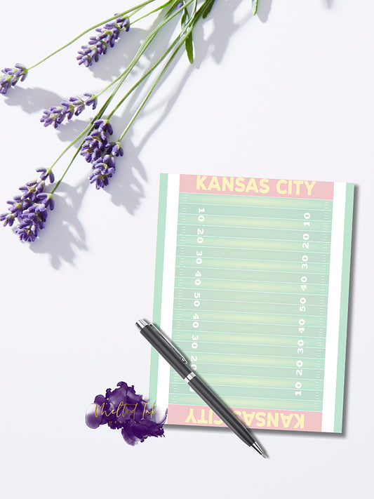 Notepad featuring a green football field design with 'Kansas City' written in each end zone, perfect for fans, coaches, and sports enthusiasts to take notes, plan, or prepare for game day.