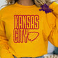 Photo is a mock up of a design. Design is red with red splatters and says Kansas City with an arrowhead. 