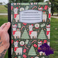 Christmas llama composition notebook with festive trees, gifts, and candy cane design.
