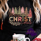 Photo is a mock up of design. Design is colored with link pink, greens, light orange. It says Merry Christmas but the I in Christmas is of a cross. 