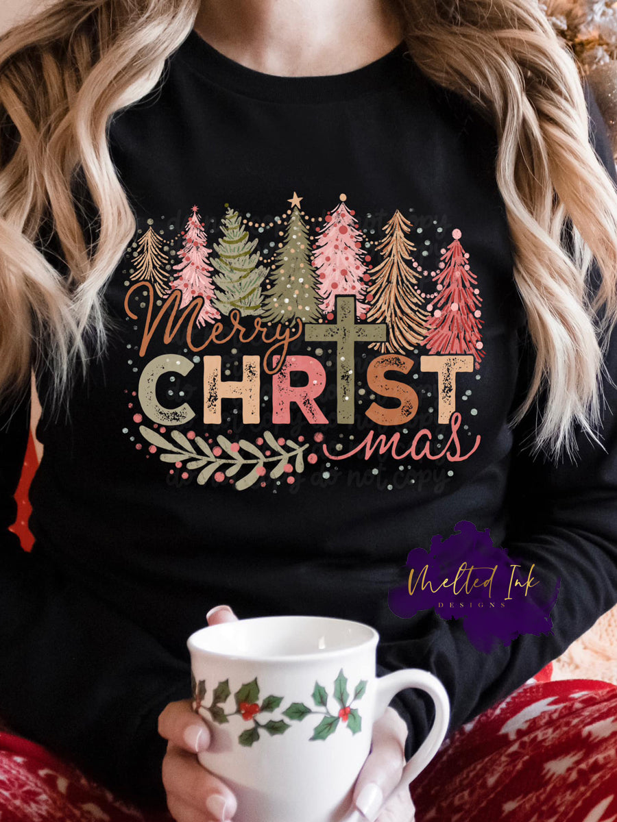 Photo is a mock up of design. Design is colored with link pink, greens, light orange. It says Merry Christmas but the I in Christmas is of a cross. 