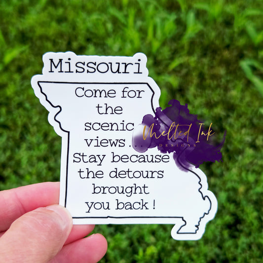Snarky Missouri-shaped sticker that says “Come for the scenic views… Stay because the detours brought you back!”