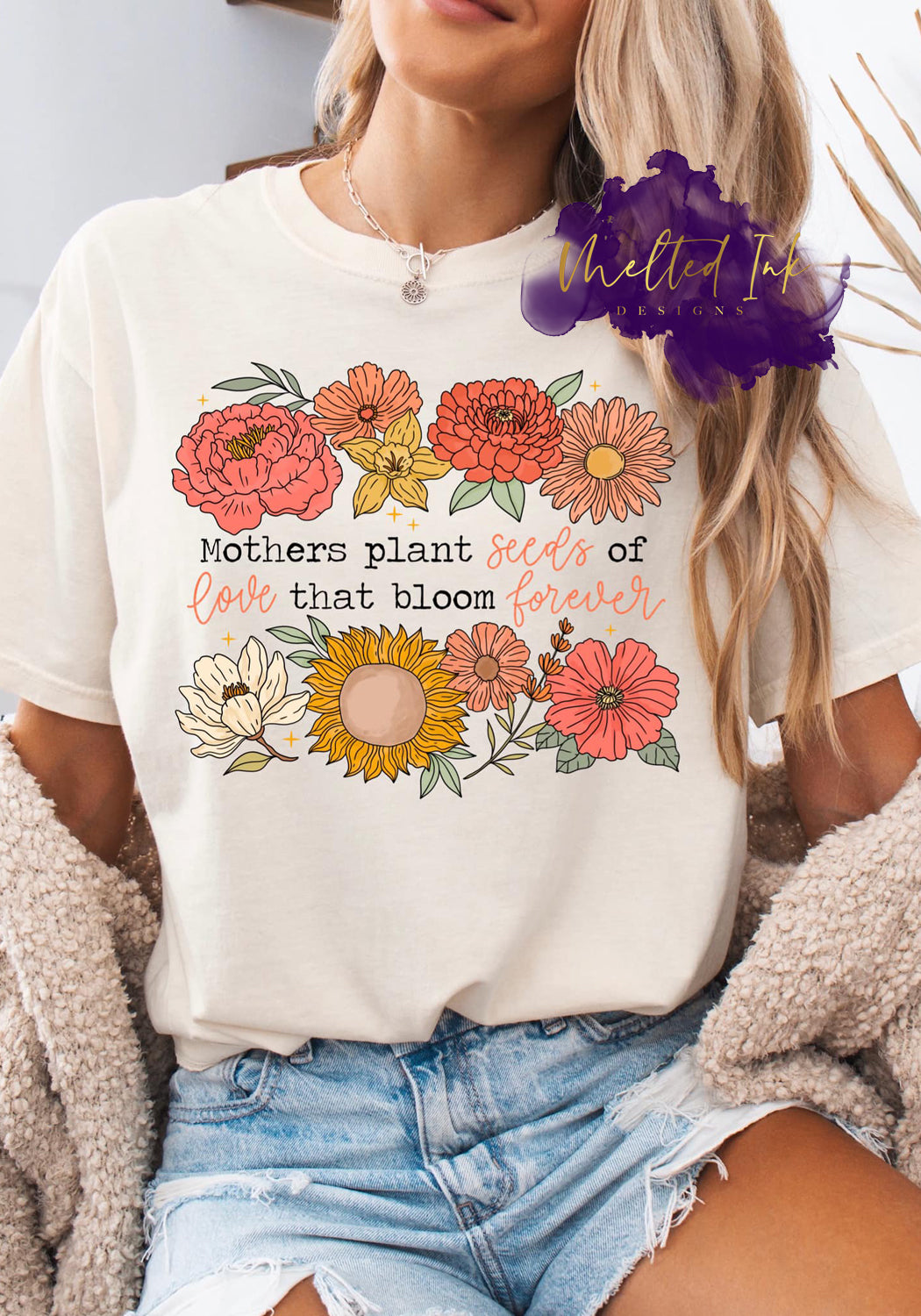 Shirt design with floral illustrations including sunflowers and zinnias, surrounding the phrase “Mothers plant seeds of love that bloom forever.” A meaningful floral design perfect for shirts, sweatshirts, and hoodies, ideal for Mother’s Day gifts.