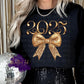 Design is a mock up on a black sweatshirt and says 2025 and has a picture of a bow. The bow is faux glitter and the design is gold. 