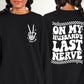 Picture shows design pressed on black crewneck as pocket design option. The front pocket design has a picture of a skeleton hand holding peace sign up with two fingers. Under it the design says wife life. 