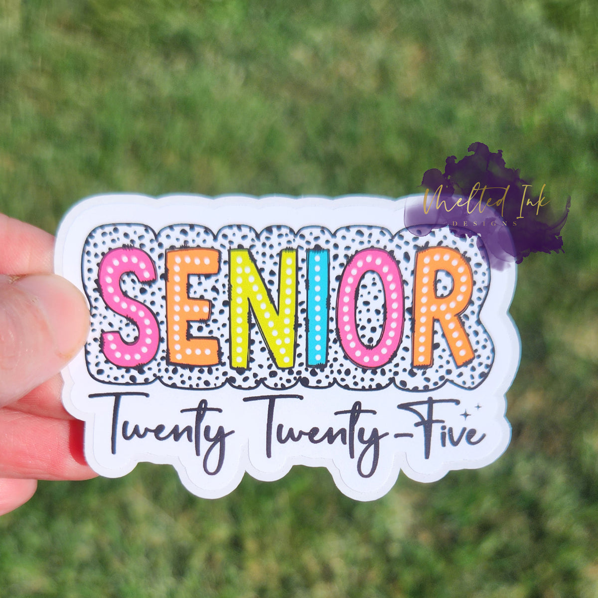 Photo is a picture of the sticker that says Senior Twenty Twenty Five. The word senior is outlined in a black polka dotted print and the year is spelled out.